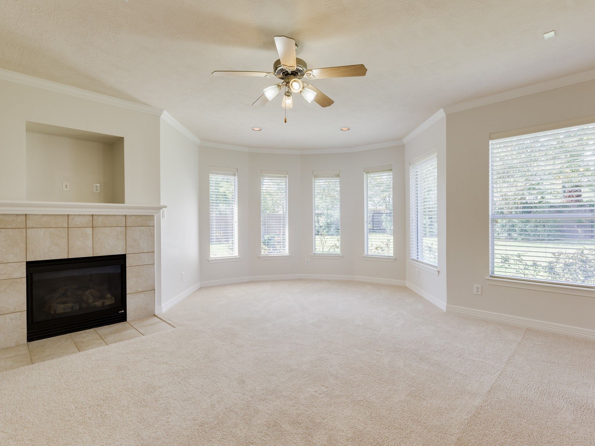 6327 Collina Springs Court Houston, TX 77041 - Photo 15 of 35 a view of livingroom with fireplace fan and windows