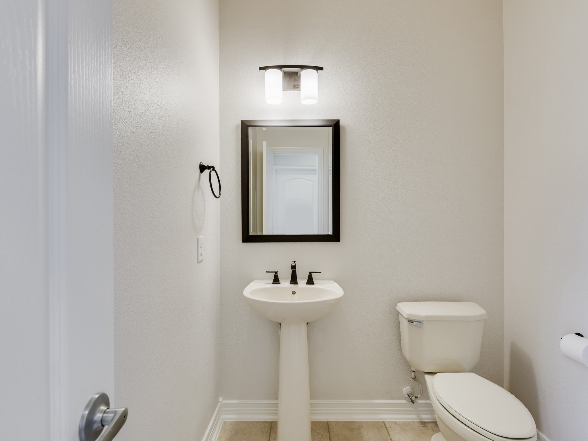 6327 Collina Springs Court Houston, TX 77041 - Photo 20 of 35 a bathroom with a toilet sink and mirror