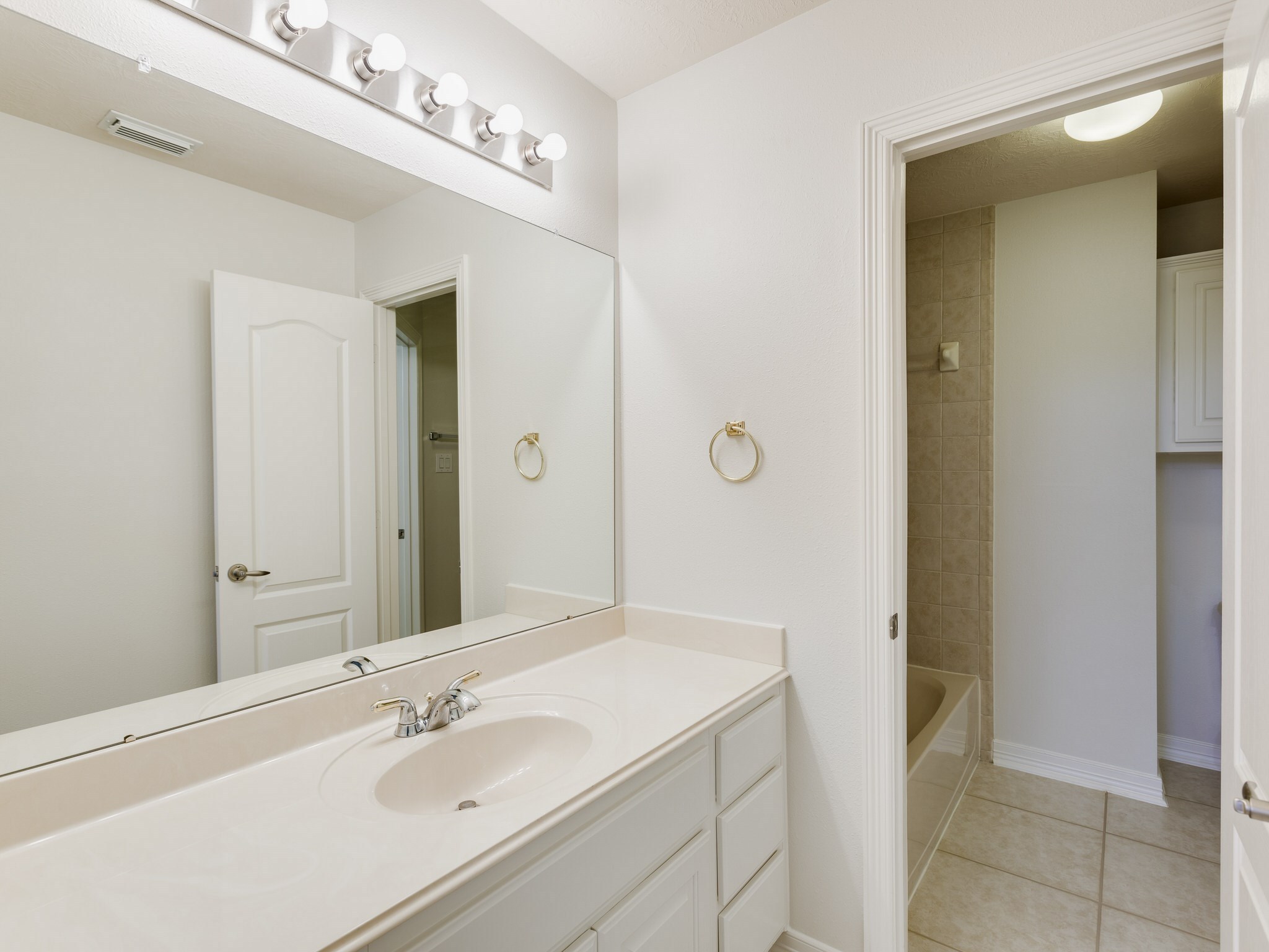 6327 Collina Springs Court Houston, TX 77041 - Photo 24 of 35 a bathroom with a sink and a mirror