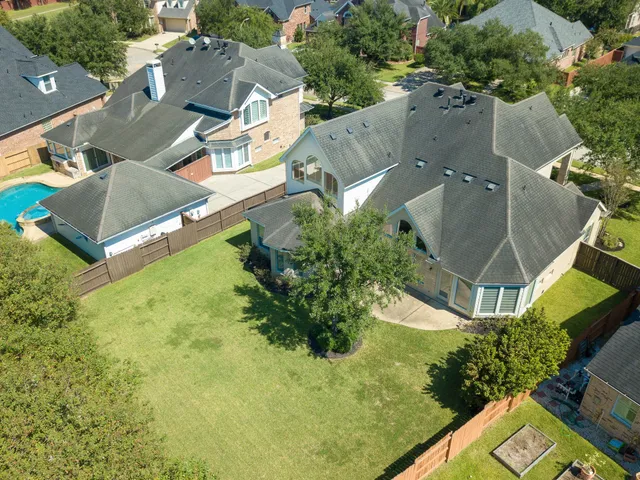 an aerial view of residential house with outdoor space and swimming pool