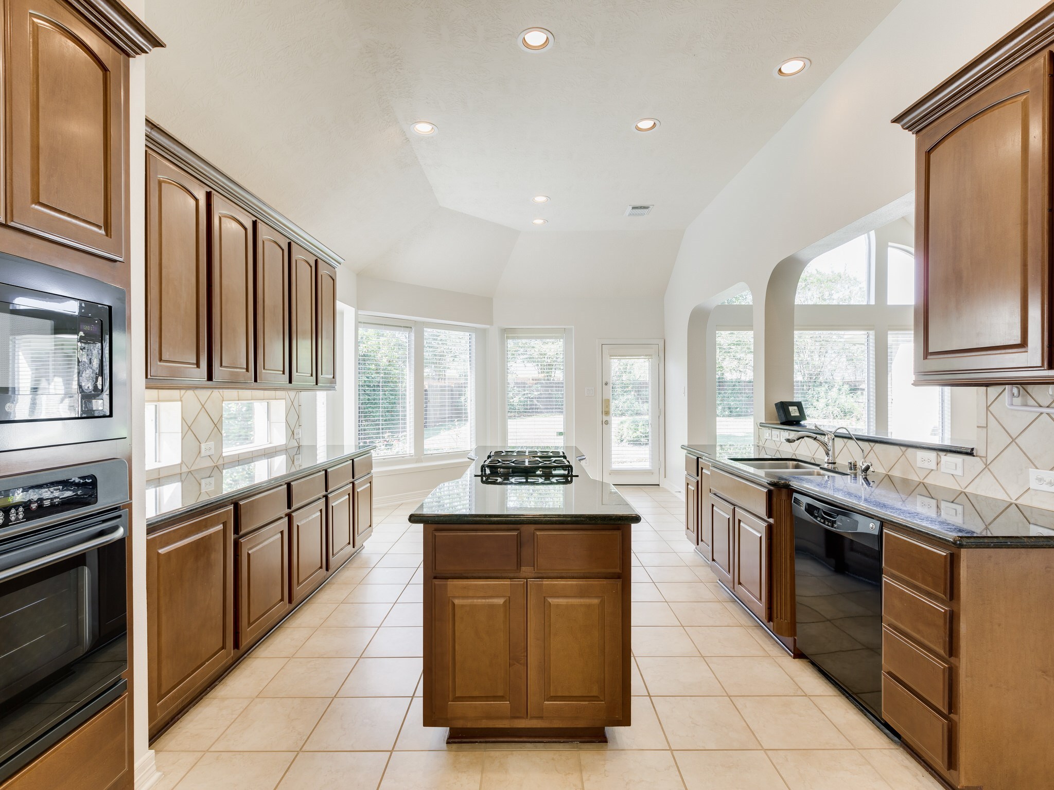 6327 Collina Springs Court Houston, TX 77041 - Photo 6 of 35 a large kitchen with stainless steel appliances granite countertop a stove and a sink