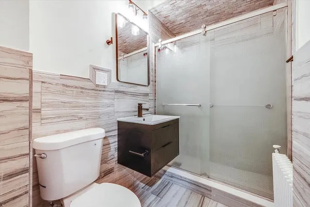 a bathroom with a sink toilet and shower