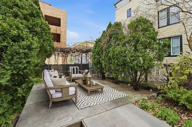 a view of a patio with table and chairs and potted plants