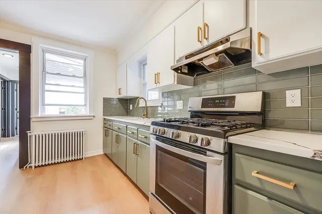 a kitchen with stainless steel appliances granite countertop a stove and a sink
