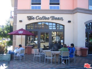 12963 West Runway Road, Unit 221 Playa Vista, CA 90094 - Photo 17 of 20 a view of a cafe with a table and chairs under an umbrella