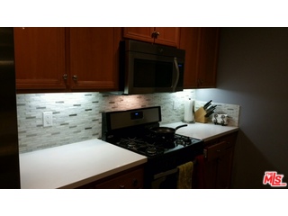 12963 West Runway Road, Unit 221 Playa Vista, CA 90094 - Photo 4 of 20 a kitchen with a sink cabinets and a stove top oven