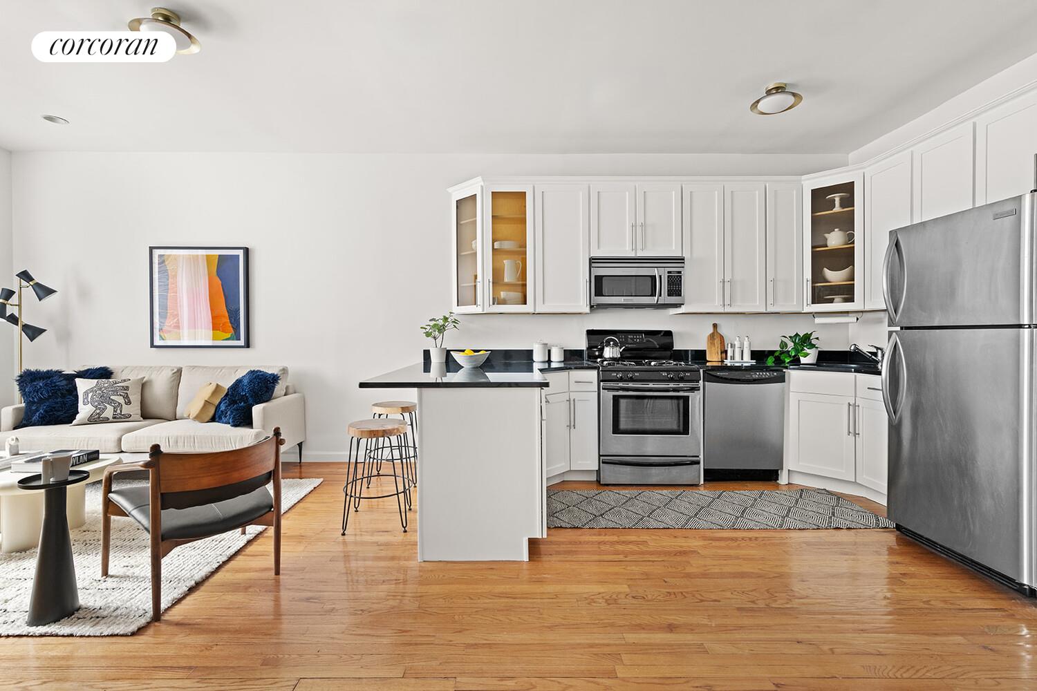 a kitchen with granite countertop a refrigerator stove top oven and sink