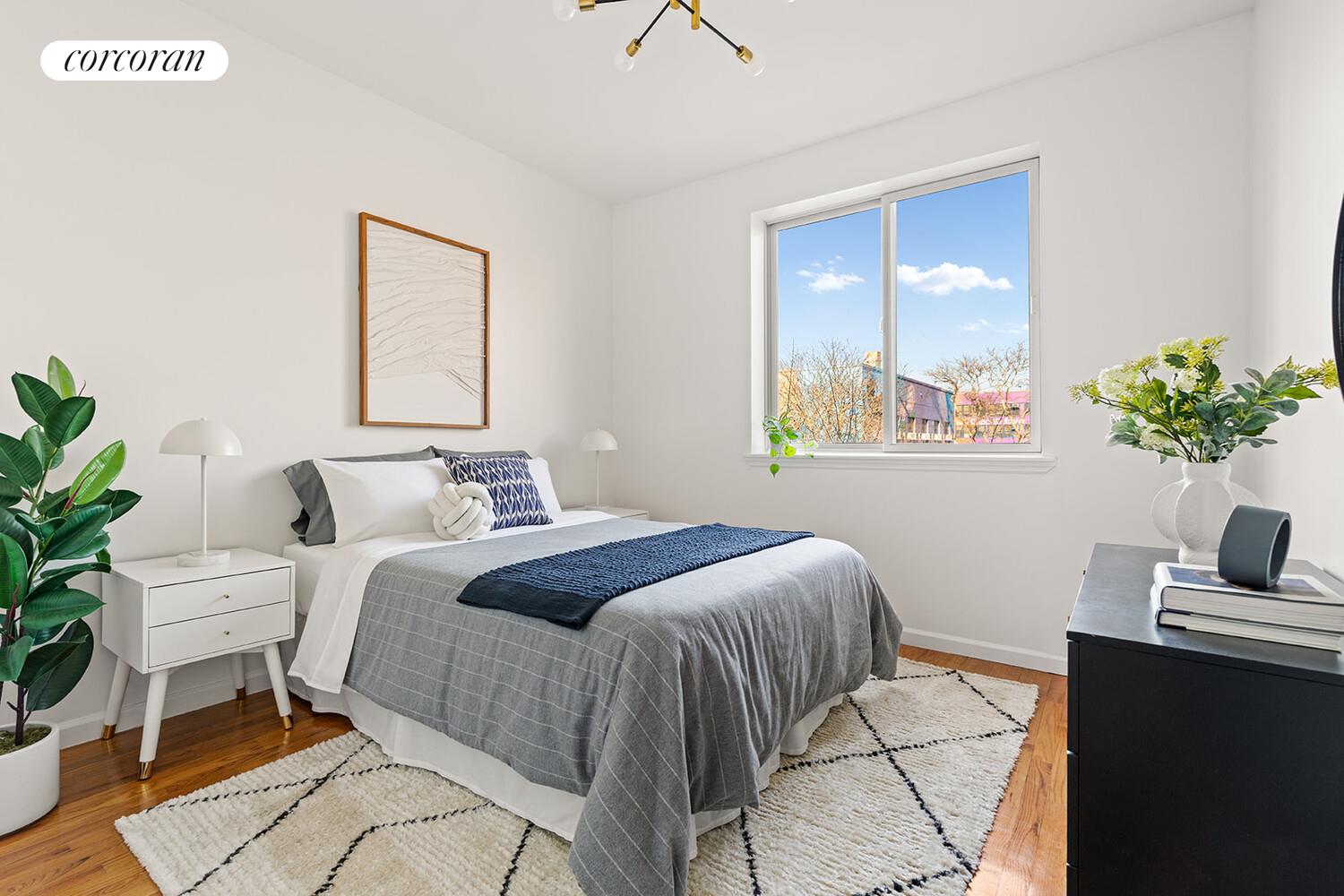 963 Kent Avenue, Unit D2 Brooklyn, NY 11205 - Photo 4 of 9 a bedroom with a bed and a potted plant