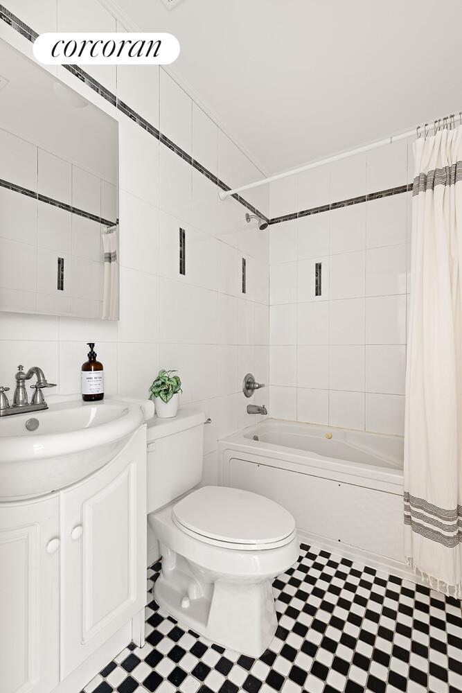 963 Kent Avenue, Unit D2 Brooklyn, NY 11205 - Photo 6 of 9 a bathroom with a sink a toilet and shower