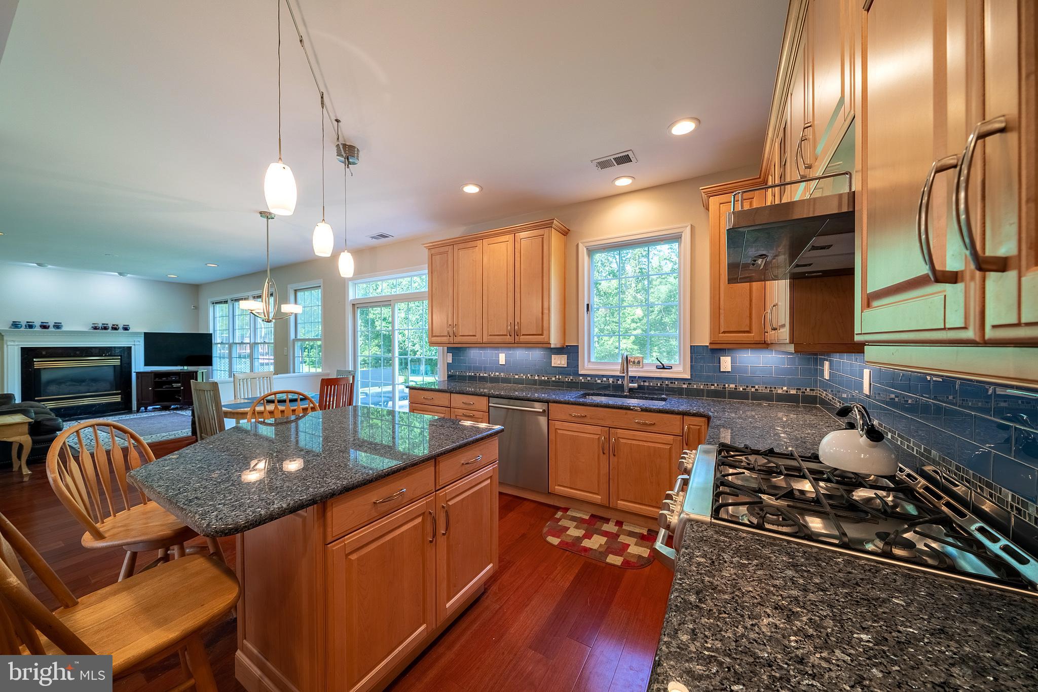 a kitchen with granite countertop lots of counter top space appliances and a window