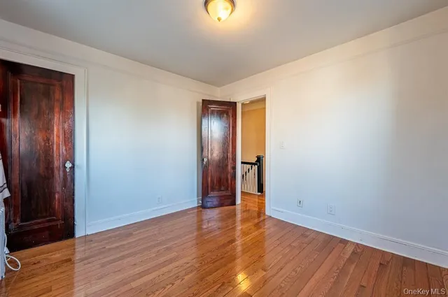 an empty room with wooden floor and closet