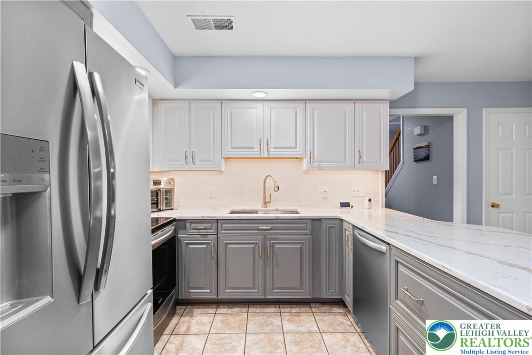 2702 Northampton Street Bethlehem, PA 18020 - Photo 14 of 51 a kitchen with a sink a refrigerator and cabinets