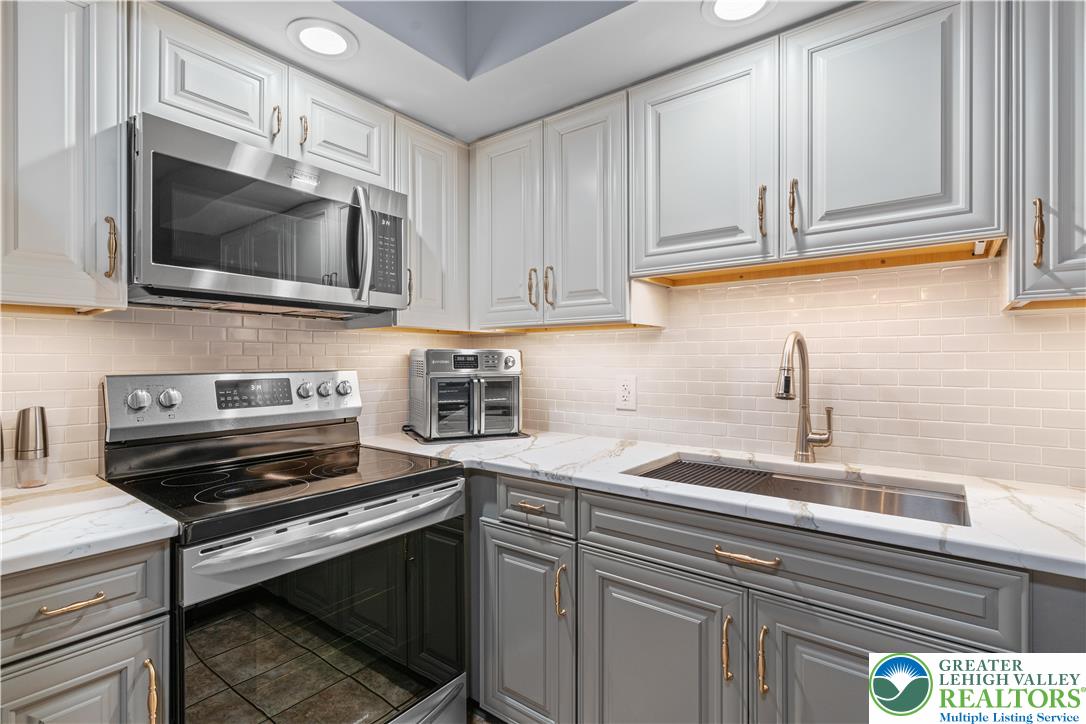 2702 Northampton Street Bethlehem, PA 18020 - Photo 16 of 51 a kitchen with a stove and a microwave