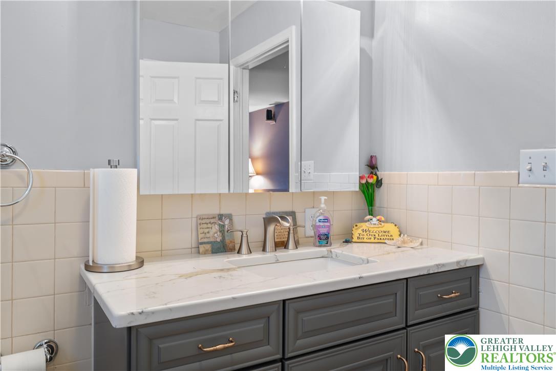 2702 Northampton Street Bethlehem, PA 18020 - Photo 24 of 51 a bathroom with a sink and a mirror