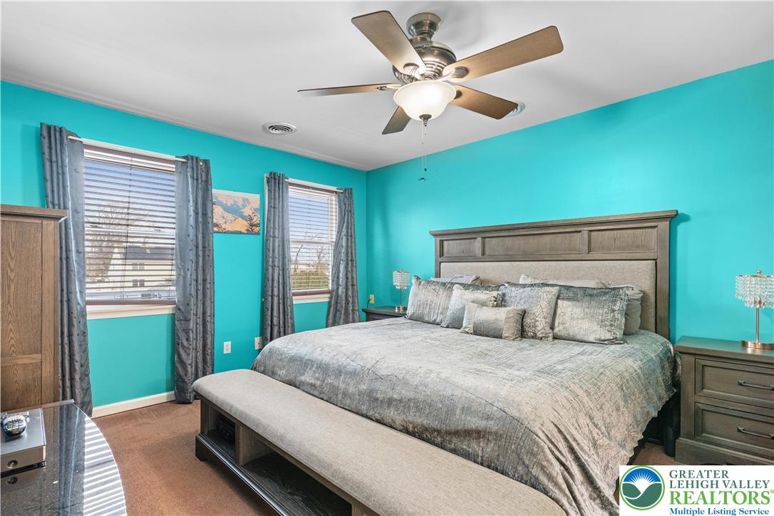 2702 Northampton Street Bethlehem, PA 18020 - Photo 26 of 51 a bedroom with a large bed and a chandelier