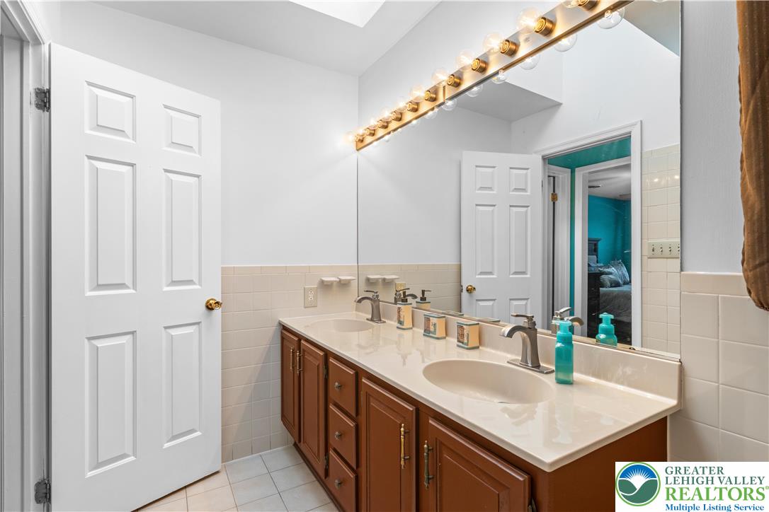 2702 Northampton Street Bethlehem, PA 18020 - Photo 29 of 51 a bathroom with a sink and a mirror