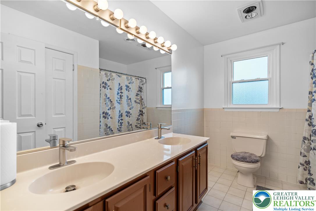 2702 Northampton Street Bethlehem, PA 18020 - Photo 37 of 51 a bathroom with a sink a toilet and mirror