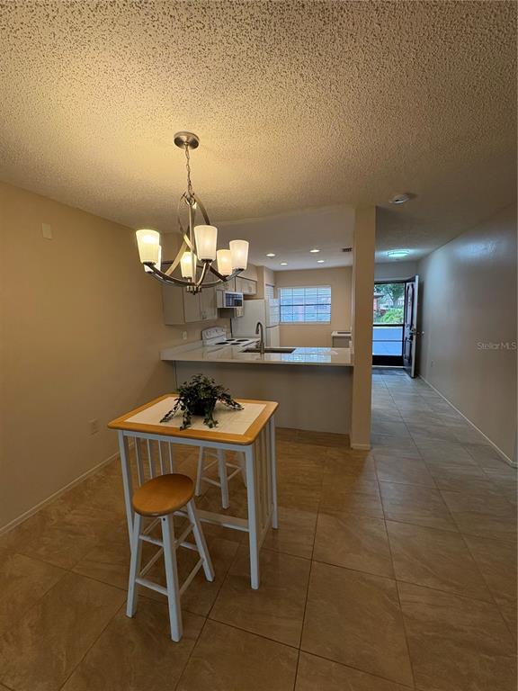 13250 Ridge Road, Unit 16 Largo, FL 33778 - Photo 11 of 28 a dining room with a table and chairs