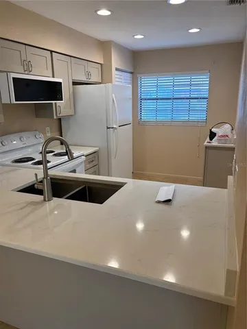a kitchen with stainless steel appliances a refrigerator sink and cabinets