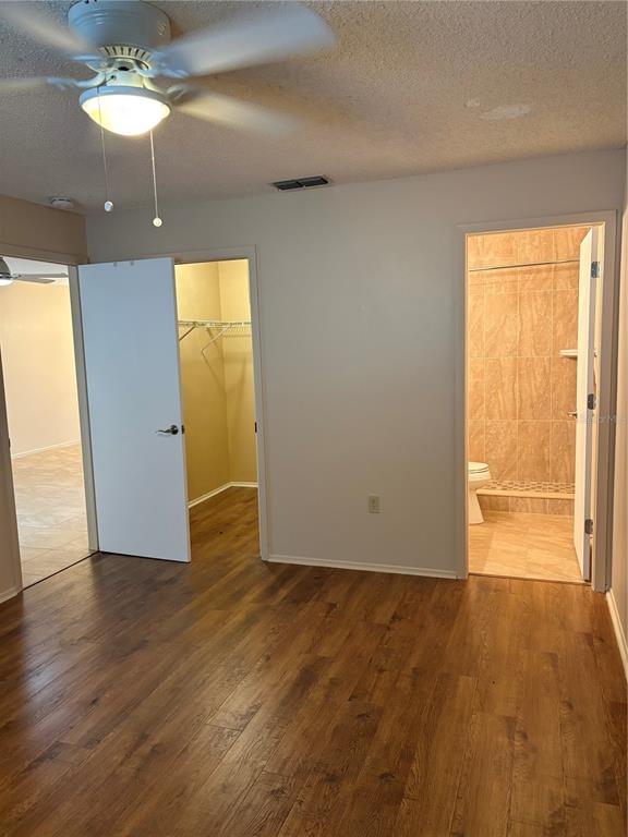 13250 Ridge Road, Unit 16 Largo, FL 33778 - Photo 16 of 28 an empty room with wooden floor and windows