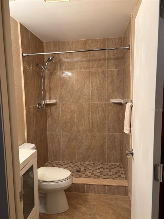 13250 Ridge Road, Unit 16 Largo, FL 33778 - Photo 20 of 28 a bathroom with a shower and a toilet