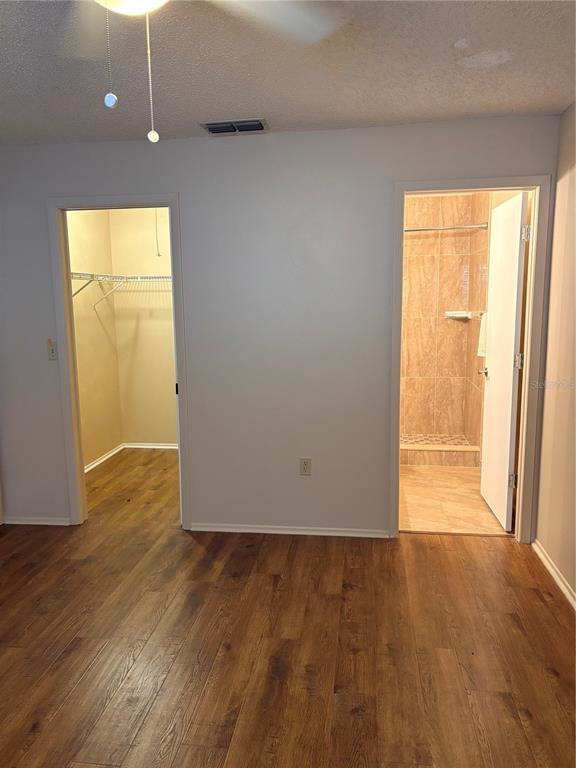 13250 Ridge Road, Unit 16 Largo, FL 33778 - Photo 21 of 32 an empty room with wooden floor and windows