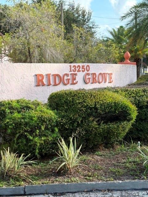 13250 Ridge Road, Unit 16 Largo, FL 33778 - Photo 25 of 28 a sign that is sitting in front of flowers