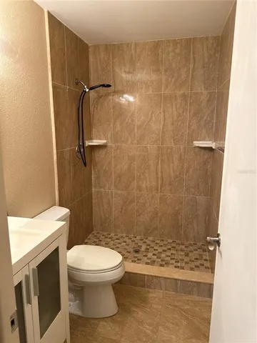 a bathroom with a toilet and a shower