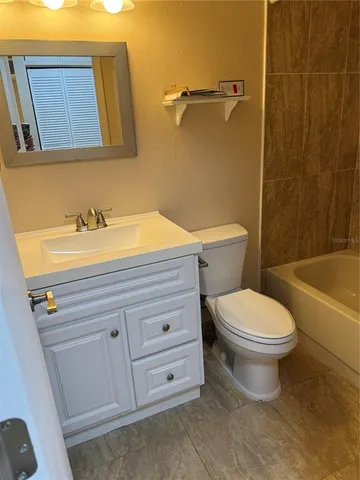 a bathroom with a toilet a sink and bathtub