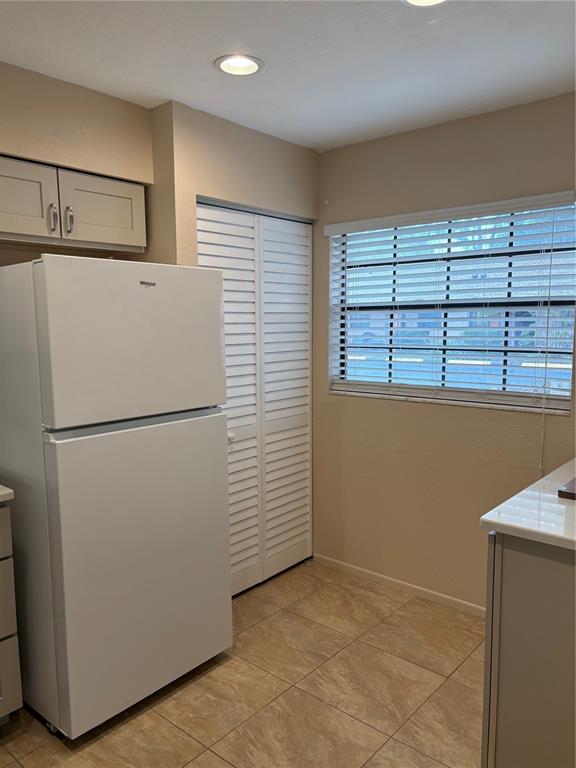 13250 Ridge Road, Unit 16 Largo, FL 33778 - Photo 6 of 28 a view of kitchen with refrigerator cabinets and wooden floor