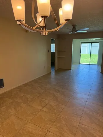 an empty room with a kitchen