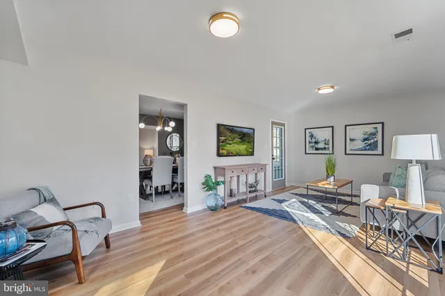 a dining room with furniture window and wooden floor