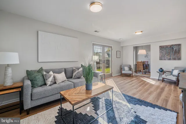 a kitchen with stainless steel appliances granite countertop a sink dishwasher a stove and a wooden cabinets