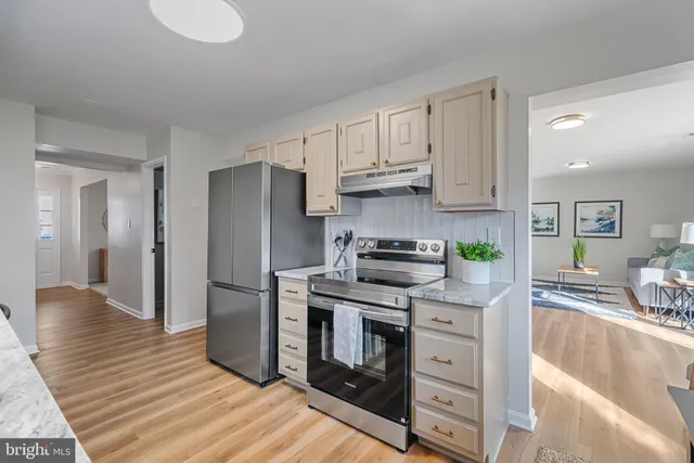 a view of a kitchen with white cabinets