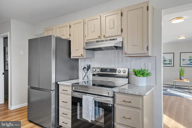 a bed room with a bed and paintings on the wall