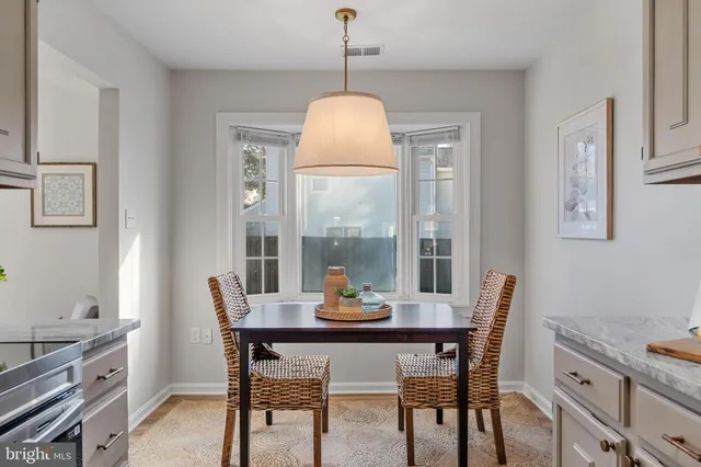 a bathroom with a sink a toilet a mirror and shower curtain