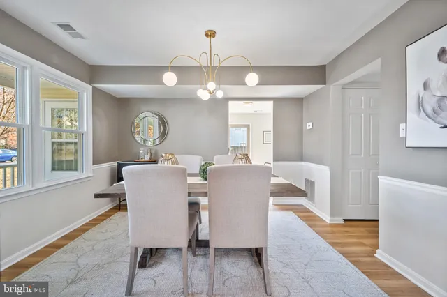 a view of a dining room with furniture wooden floor and chandelier
