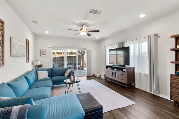 a view of an entryway with wooden floor and a livingroom