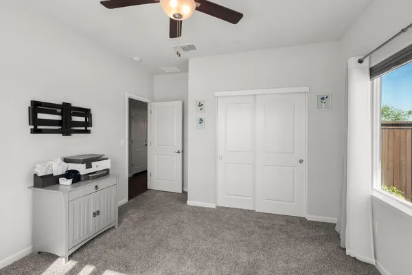 a bathroom with a granite countertop sink a toilet a mirror a bathtub and shower