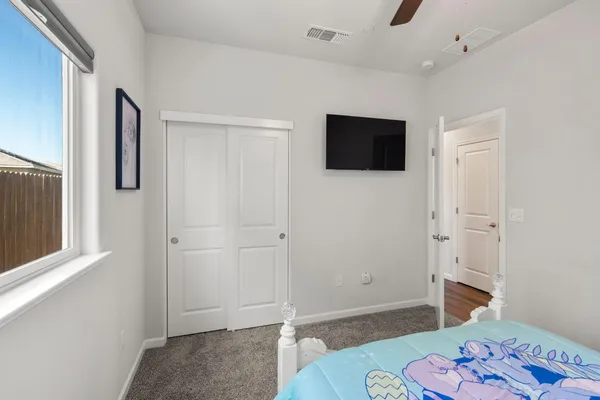a view of a livingroom with furniture and a flat screen tv