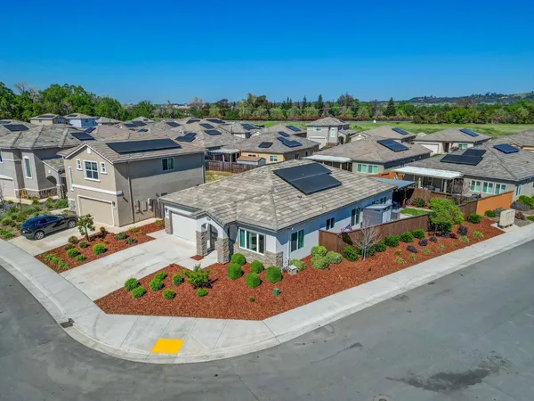 an aerial view of residential houses with outdoor space and swimming pool