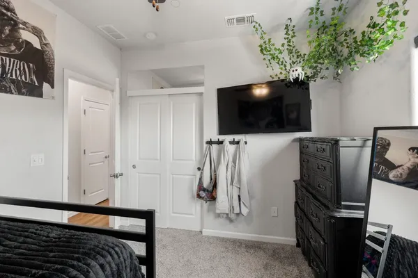 a bedroom with a bed and cabinets