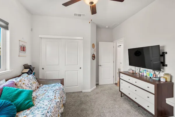 a bedroom with furniture and a window