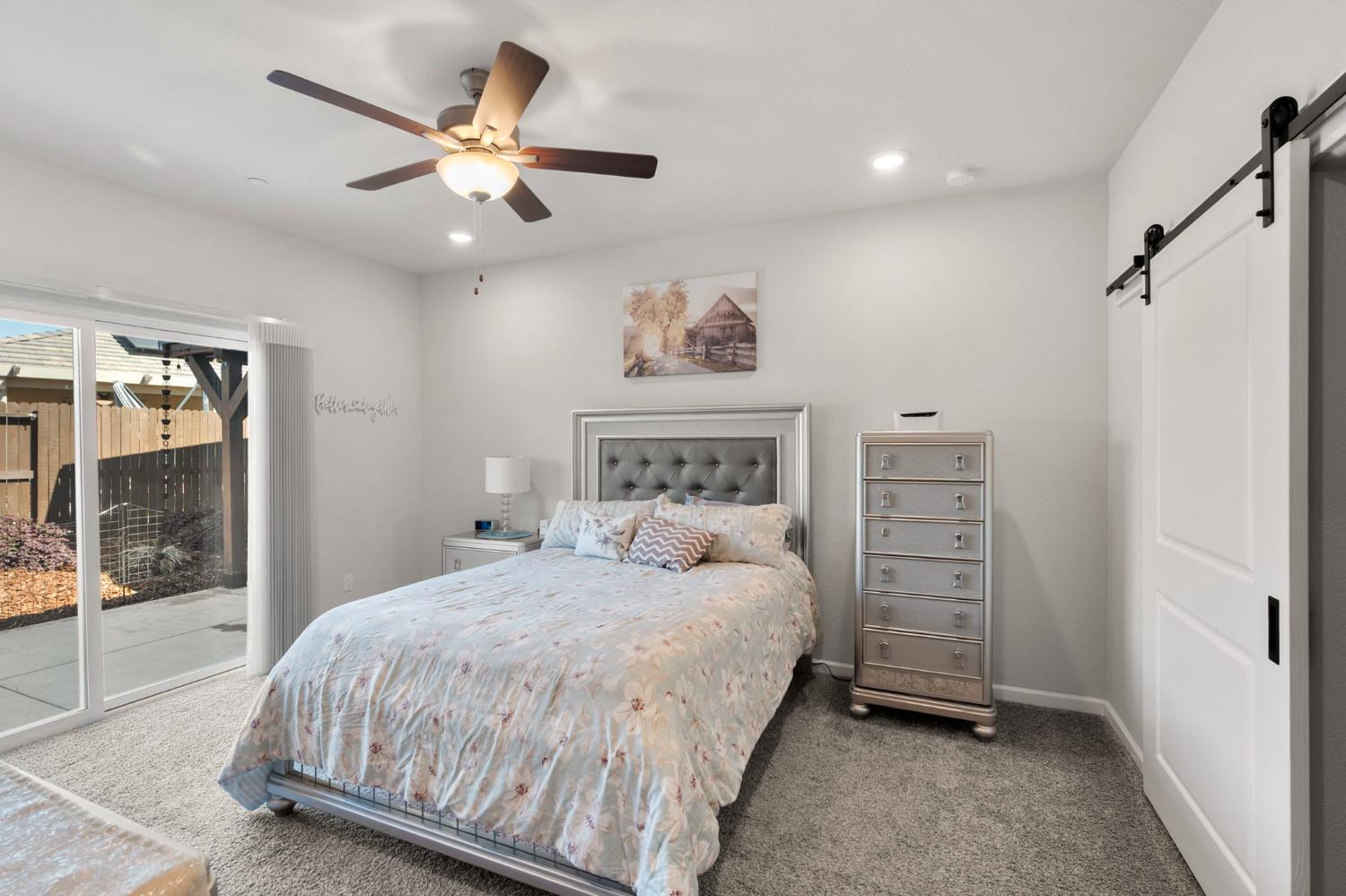 1500 Lahonton Way Ione, CA 95640 - Photo 25 of 52 a bedroom with a large bed and a chandelier
