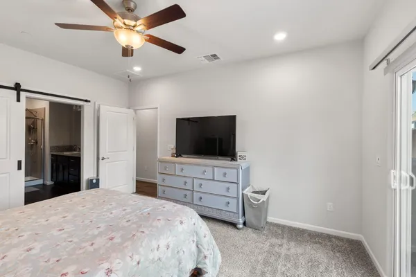 a bathroom with a granite countertop sink a large mirror a shower and a bathtub