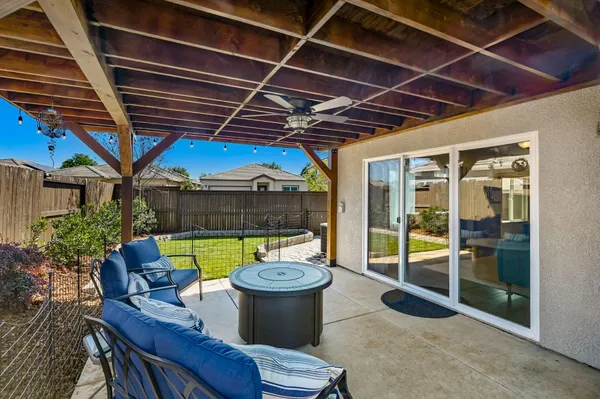 a kitchen with stainless steel appliances granite countertop a dining table chairs stove refrigerator and cabinets