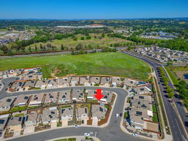 an aerial view of a house with a yard