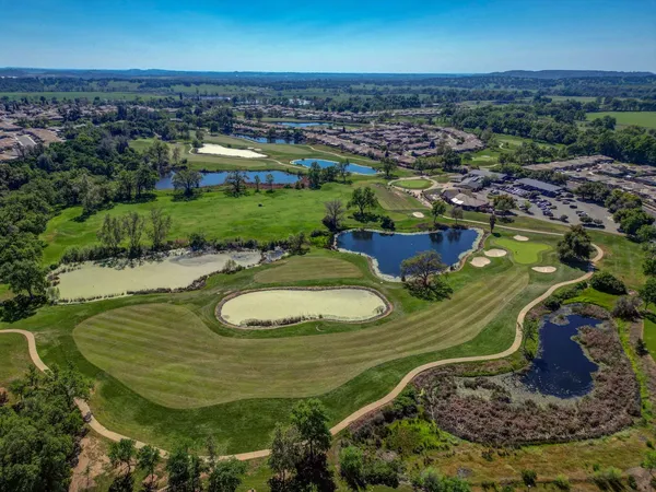 an aerial view of a house with big yard