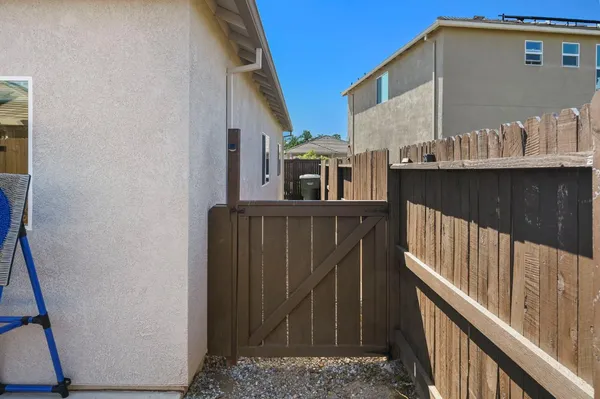 a front view of a house with a yard and potted plants