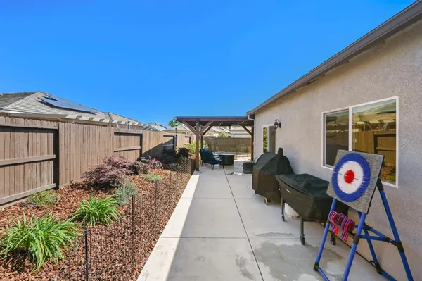 an aerial view of a house with garden space and sitting area